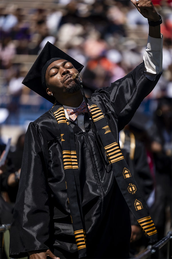 Photo of Langston University graduation candidate with his hand in the air in celebration