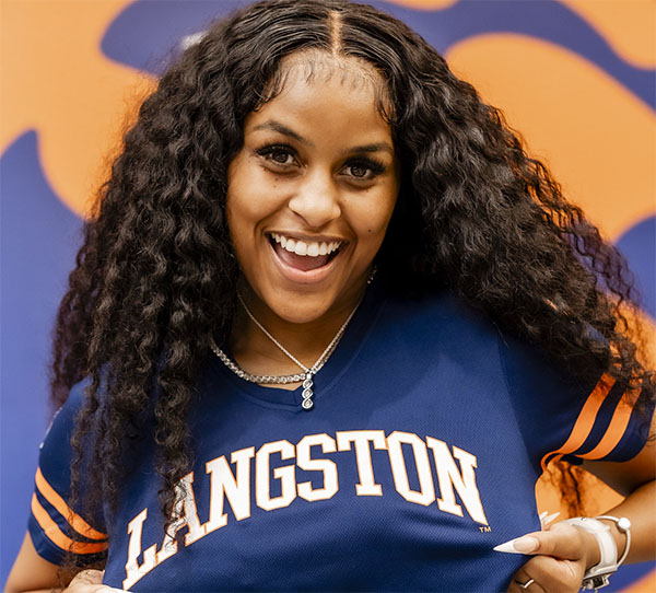 Female student smiling in a Langston tshirt