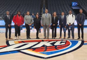 LU students smile and pose on the Oklahoma City Thunder basketball court after the "Careers in Sports Event with OKC Thunder."