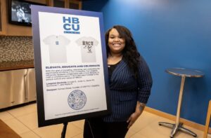 Aniyah Robinson poses next to an HBCU night t-shirt design