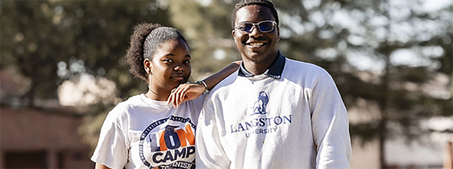 Female and male Langston University students with Lion Camp shirts