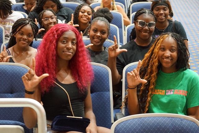 Photo of Lion Camp students. Front two students have L's up.