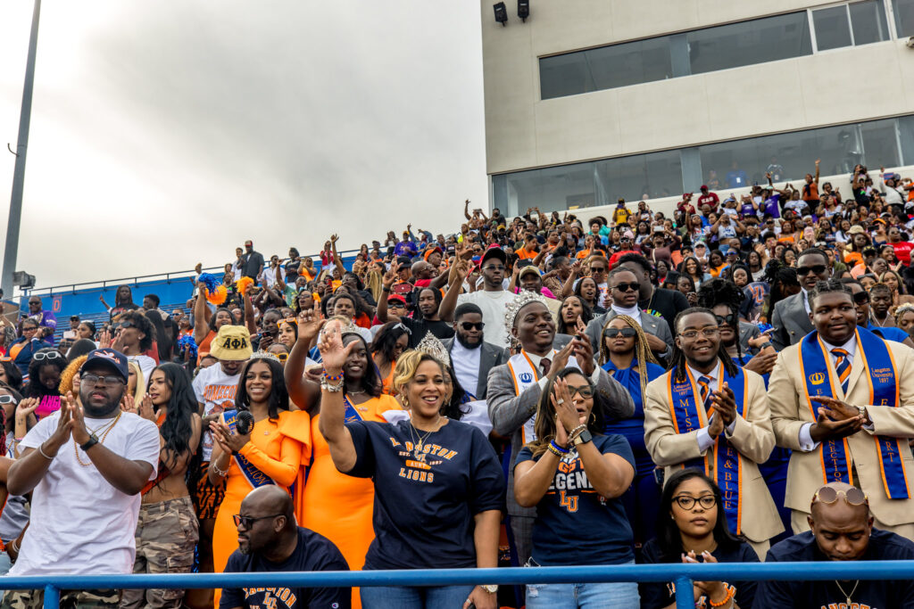 Crowd cheering on the Langston Lions football team at Homecoming