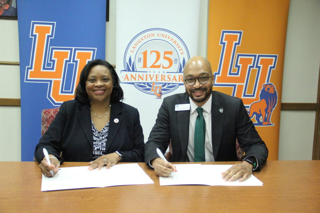 Langston University President Ruth Ray Jackson (left) and Arkansas Colleges of Health Education Assistant Provost and Director of DEI Christopher Smith sign an education agreement creating the Early Assurance Program.