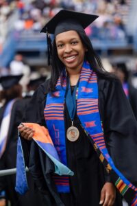 Alexis Barnett walks across the stage at graduation