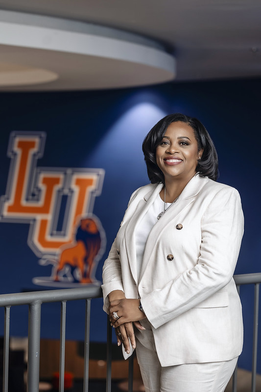 President Jackson in SSC, 2nd floor with LU logo in backdrop