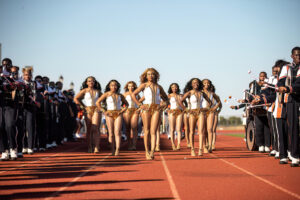 Golden Feline Dancers march in formation