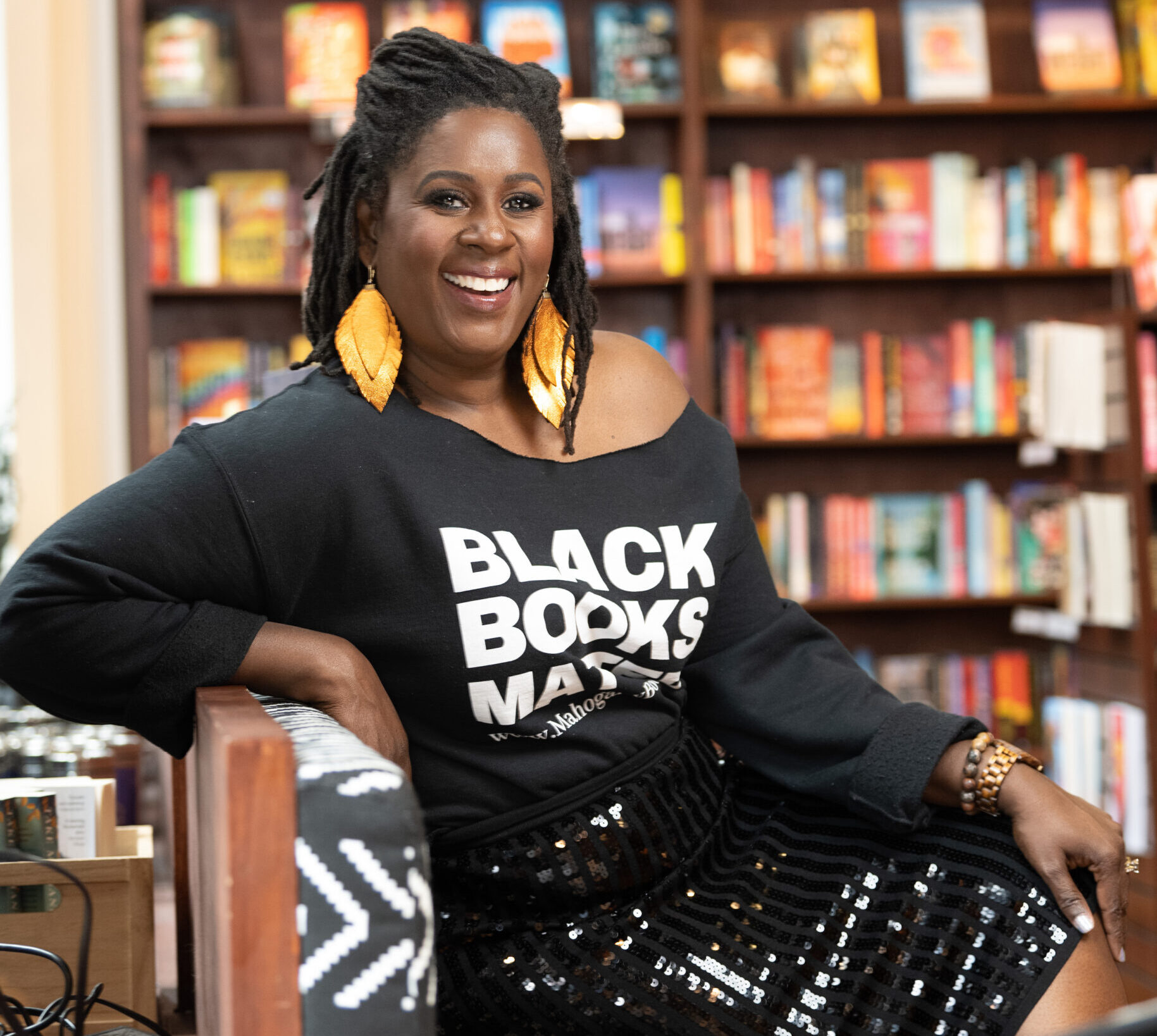 Ramunda Lark Young posed in front of bookshelves.