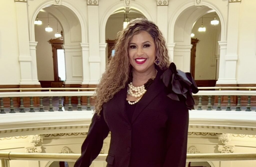 Chelle Luper Wilson standing on a balcony in the Texas Capitol Building.