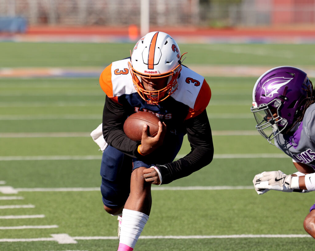 Langston University Football Player #3 rushes for the end zone as an opponent attempts to tackle him.