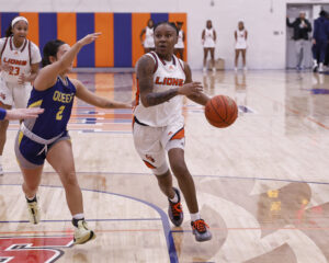 Mikayla Woods dribbles a basketball