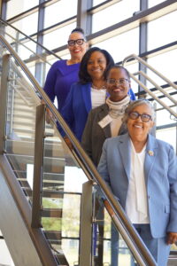 Diana Sharp, President Ruth Ray Jackson, Dr. Sherri Smith Keys, and Dr. Emily Patterson Harris pose on the stairs of the LU-Tulsa campus.