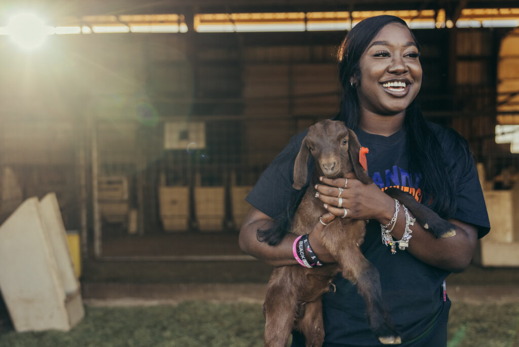 Student holding baby goat at LU