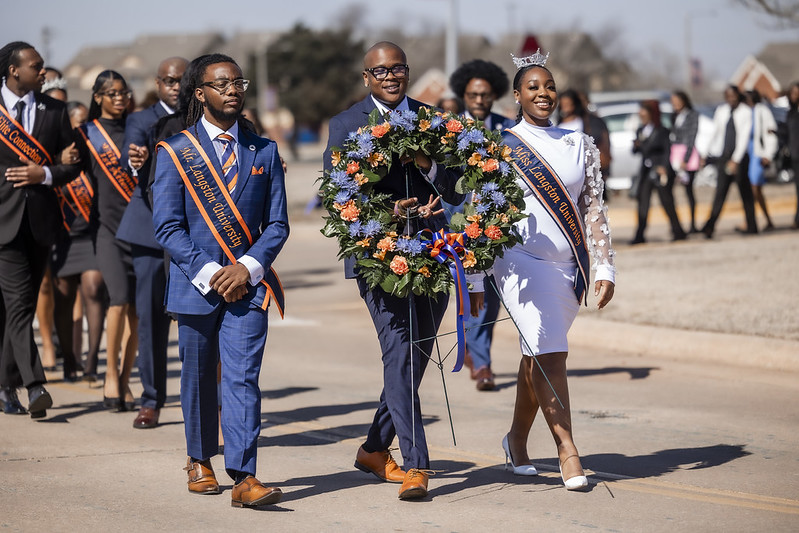 Students walking with wreath to Inman Page grave after Founders Day