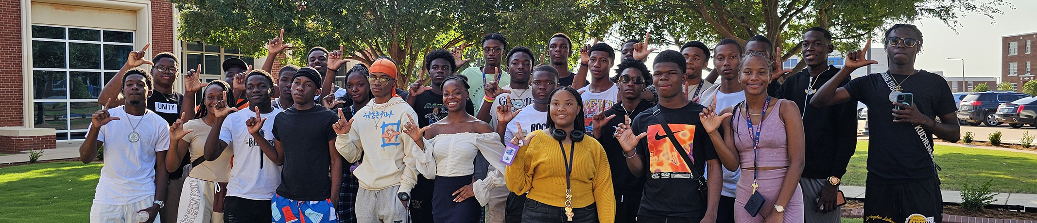 Photo-of-Bahamian-students-posed-with-Ls-up-outside-on-Langston-campus