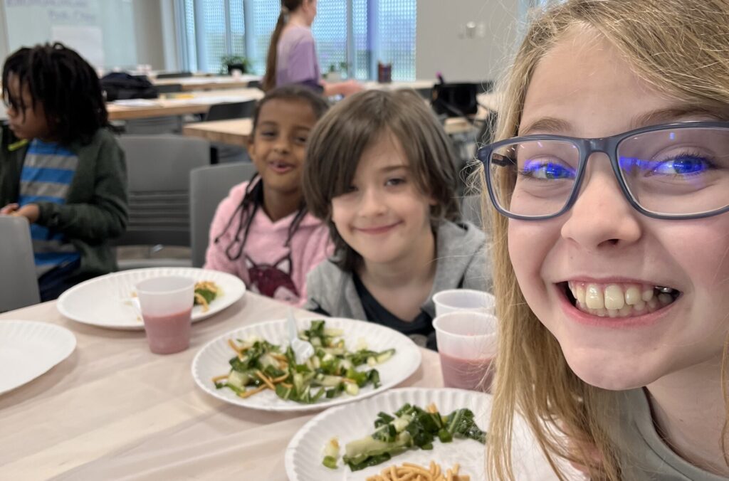 children in 4H smile while holding their plates of homegrown and prepared food