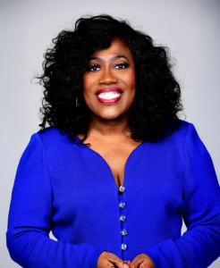Photo of Sheryl Underwood from waist wearing a royal blue dress