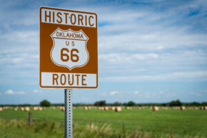 photo of Oklahoma route 66 sign in front of a field