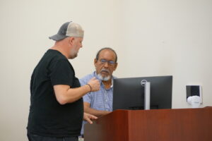 Herron talks to one of his students before class begins