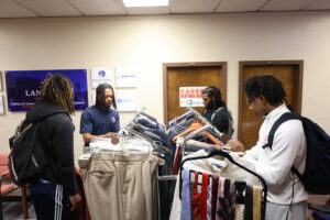 LU students look through racks of men's business clothes