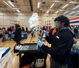 A student conducts an experiment to change the color of fire.