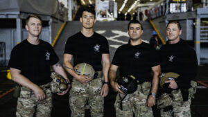 the U.S. Navy dive medical team pose for a group photo in uniform