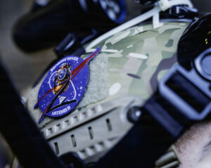 A patch on the helmet of a U.S. Navy diver that reads Recovery Diver Artemis 2