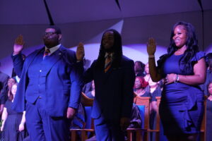 2026 SGA Officers dressed in formal attire raising their right hands as they take the oath of office