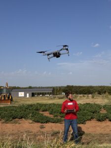 Braylon Hood Colbert posing with the drone he is piloting