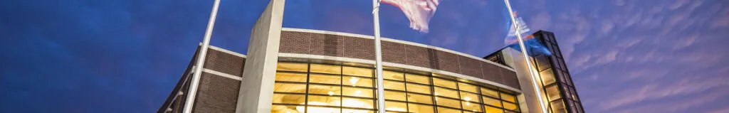 Photo facing the front of LU-Tulsa at evening. The lights inside the building are on in this evening photo with the Langston University letters/sign in the front of the building.